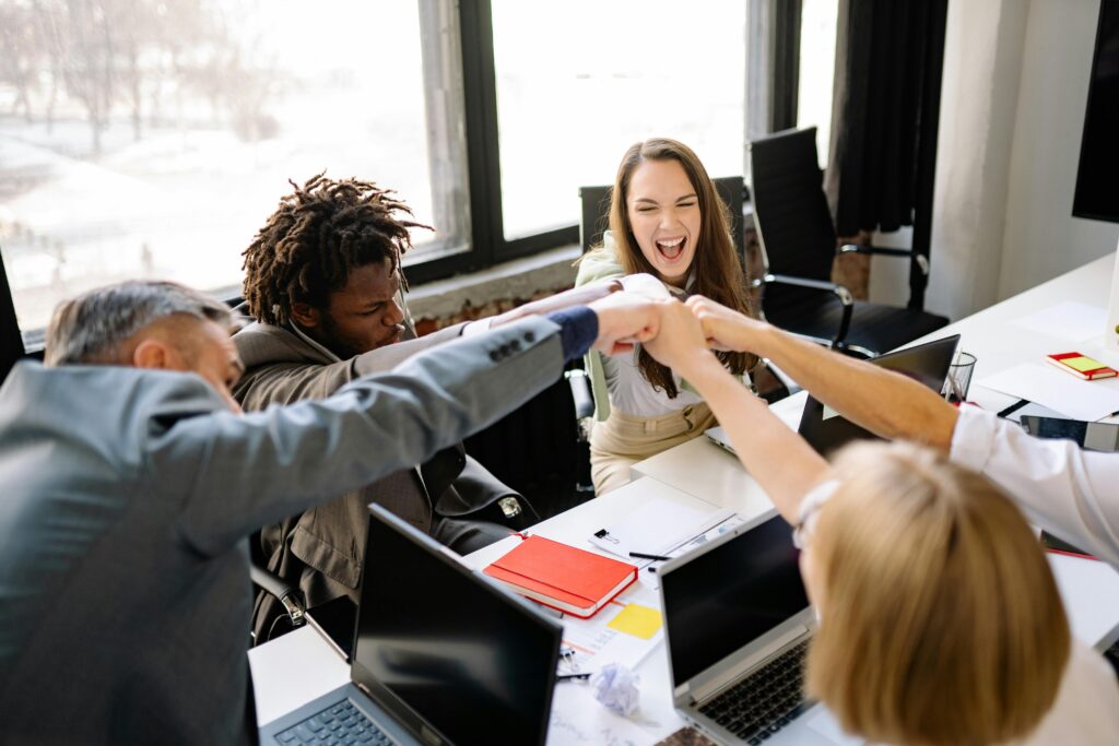 Triumphant colleagues doinga fist bump